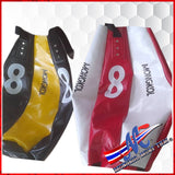 Unfilled Mongkol balloon-style bag. A balloon-style muay Thai bag is a large,  punching and kicking bag designed for use in muay Thai Black and yellow red and white